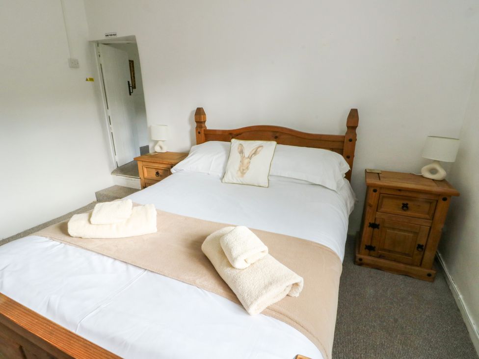 A bedroom with a bed and bedside tables at Pen Bonc in Llanddaniel Near Gaerwen