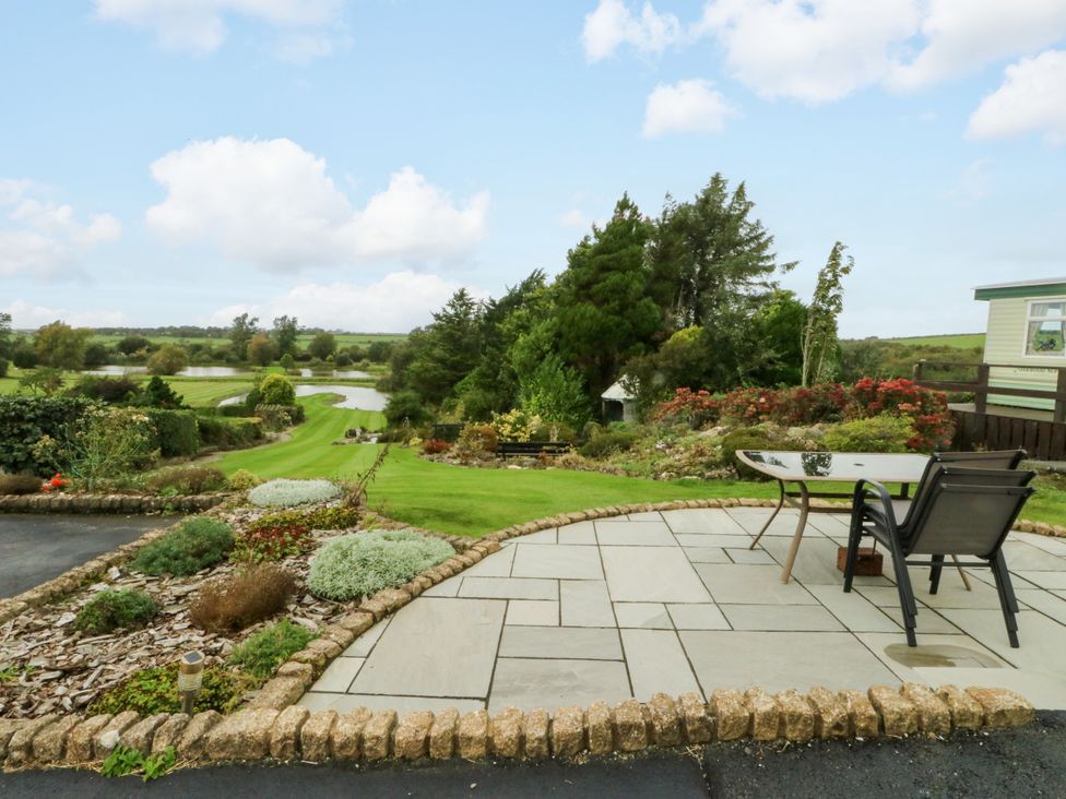 An outdoor area with a table and chairs at Pen Bonc Llanddaniel Near Gaerwen