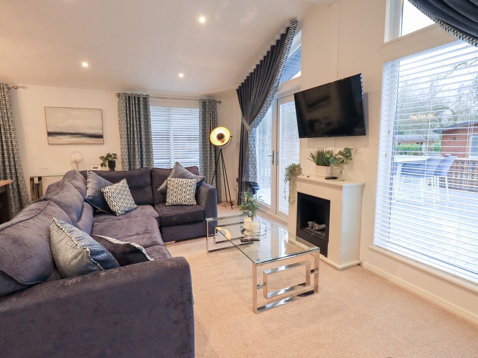 A living room with a sofa and coffee table at Unique Luxury Lodge, 1 Langdale, White Cross Bay near Windermere
