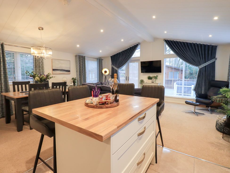 A dining area with a table and chairs at Unique Luxury Lodge 1 Langdale, White Cross Bay near Windermere