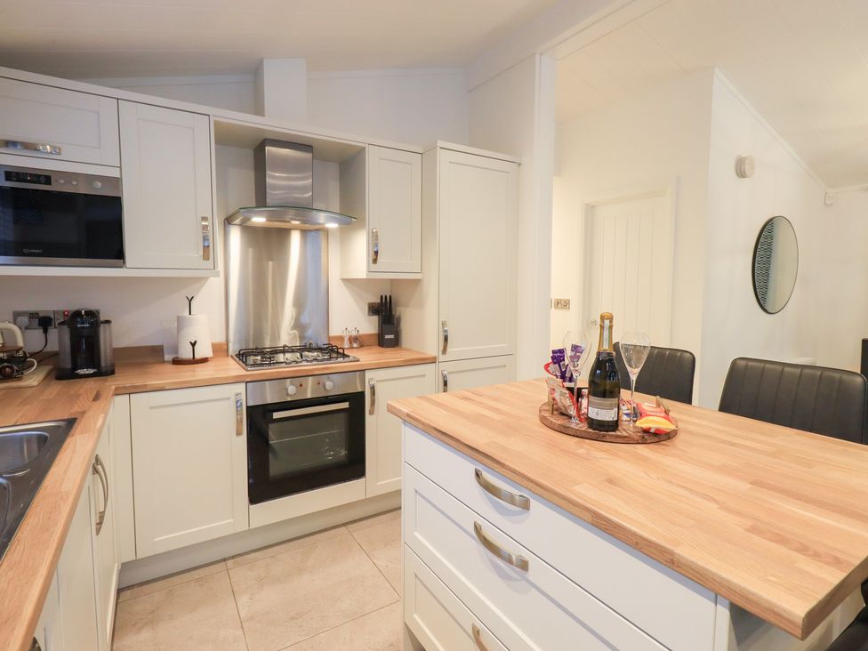 A kitchen with modern appliances at Unique Luxury Lodge, 1 Langdale, White Cross Bay near Windermere