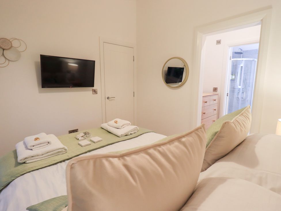 A bedroom with a bed and television at Unique Luxury Lodge, 1 Langdale, White Cross Bay near Windermere