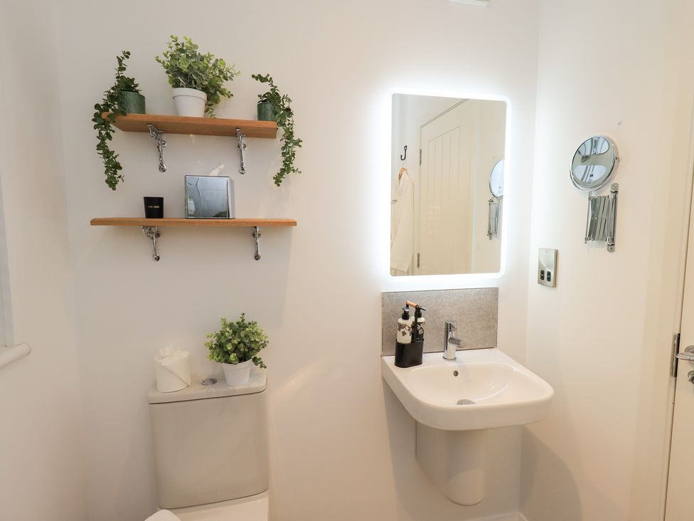 A bathroom with a sink and a toilet at Unique Luxury Lodge, 1 Langdale, White Cross Bay near Windermere