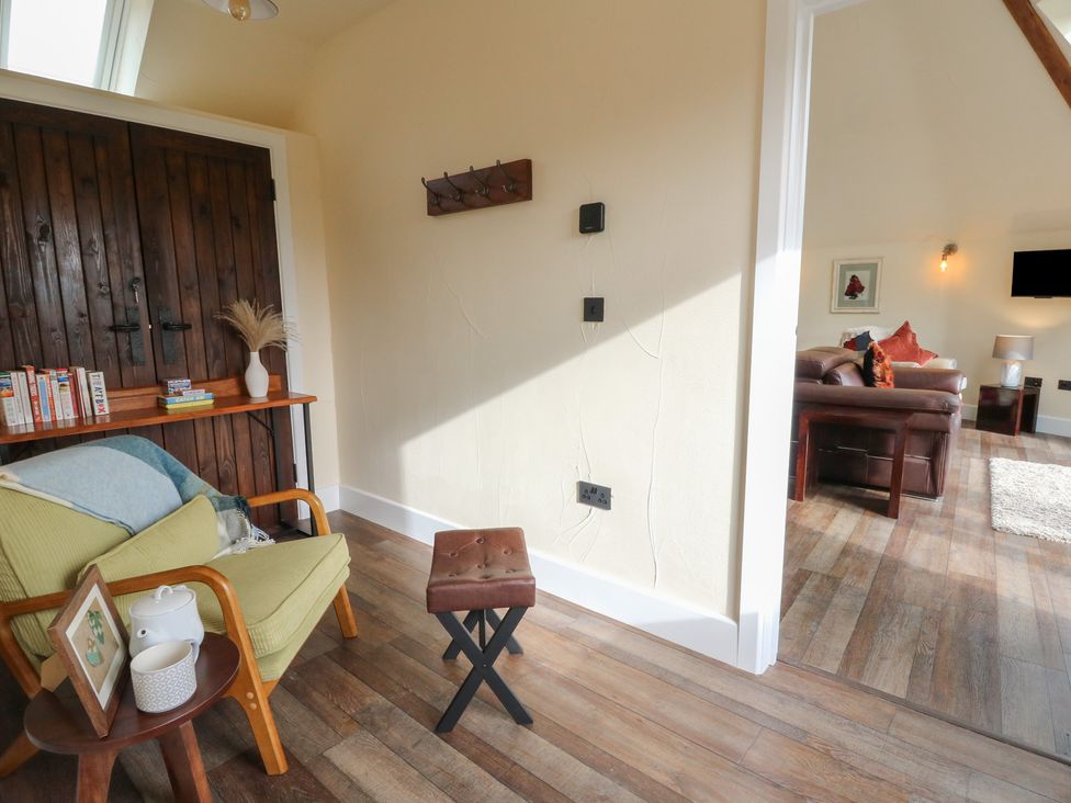 A snug with wooden doors and furniture at Ty Crwn Lampeter