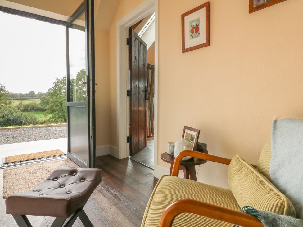 An entrance with a chair and door at Ty Crwn in Lampeter