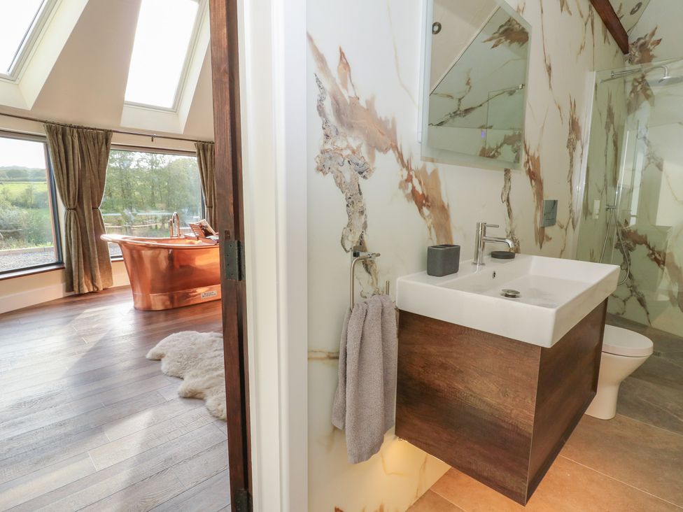 A bathroom with a sink and bathtub at Ty Crwn in Lampeter