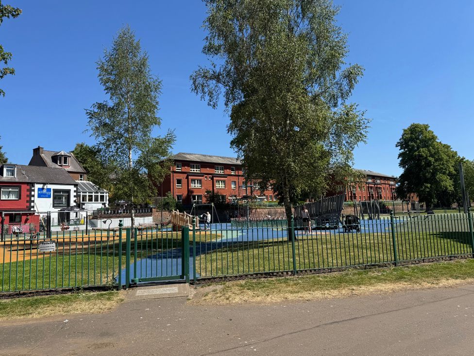 A playground with swings and trees at The Steading Terregles near Dumfries