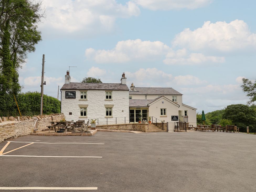 An outdoor pub with seating area and parking at Upstairs at the White Lion in 