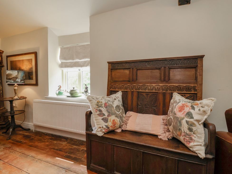 A sitting room with a sofa and a window at Upstairs at the White Lion