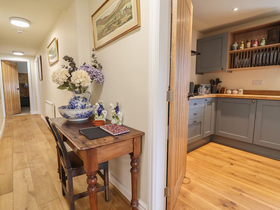 A hallway with a table and kitchen view at Upstairs at the White Lion