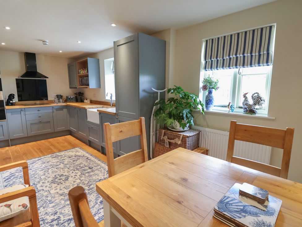 A kitchen with wooden table and chairs at Upstairs at the White Lion