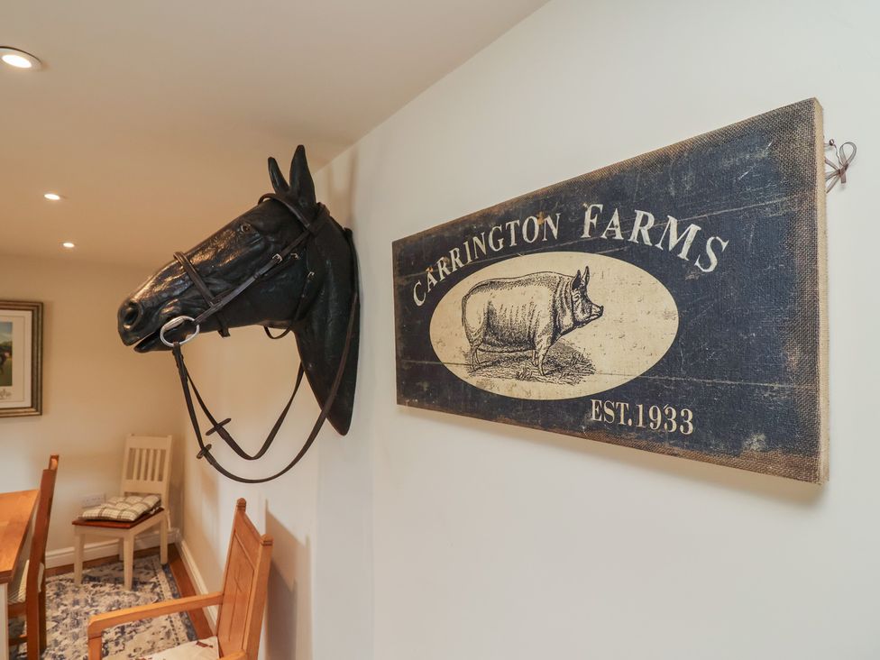 A dining room with a horse head mount and a Carrington Farms sign at Upstairs at the White Lion