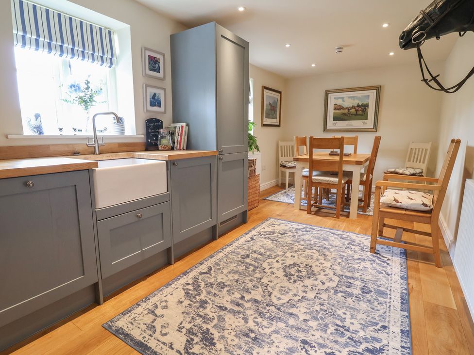 A kitchen with a sink and dining area at Upstairs at the White Lion