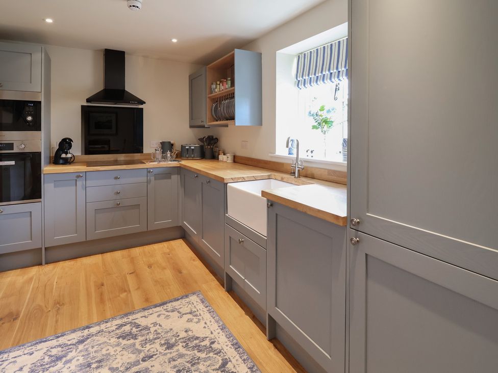 A kitchen with cabinets and a sink at Upstairs at the White Lion