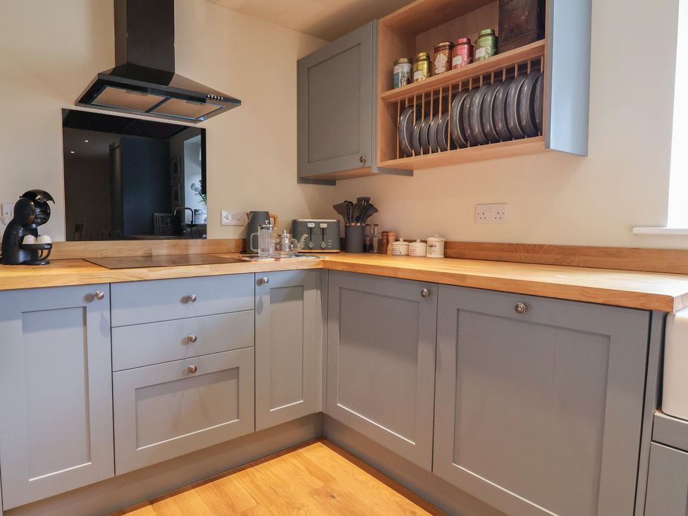 A kitchen with cabinets and a countertop at Upstairs at the White Lion