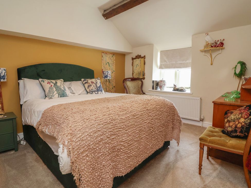 A bedroom with a bed and decor at Upstairs at the White Lion 