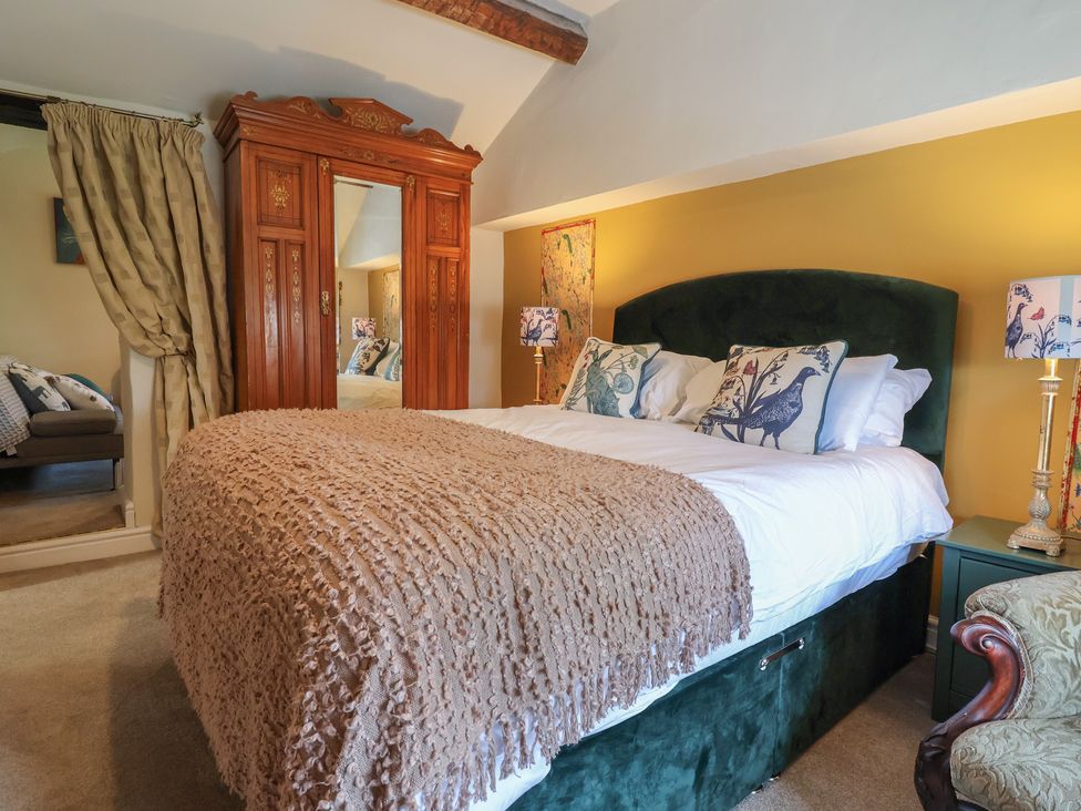 A bedroom with a bed and wardrobe at Upstairs at the White Lion in 