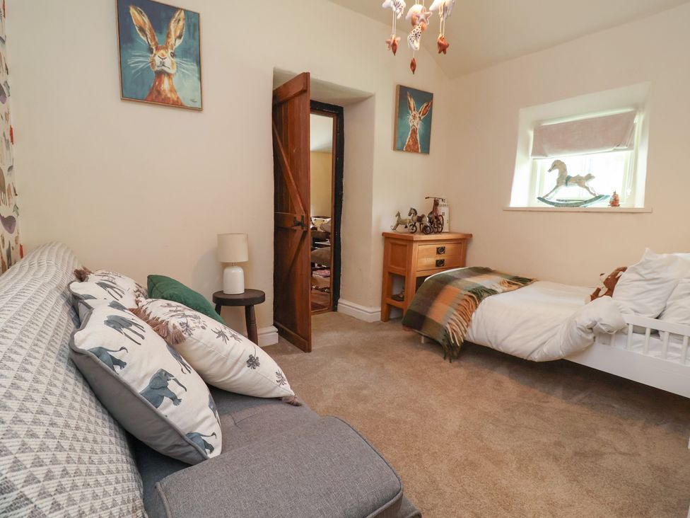 A bedroom with a bed and a sofa at Upstairs at the White Lion