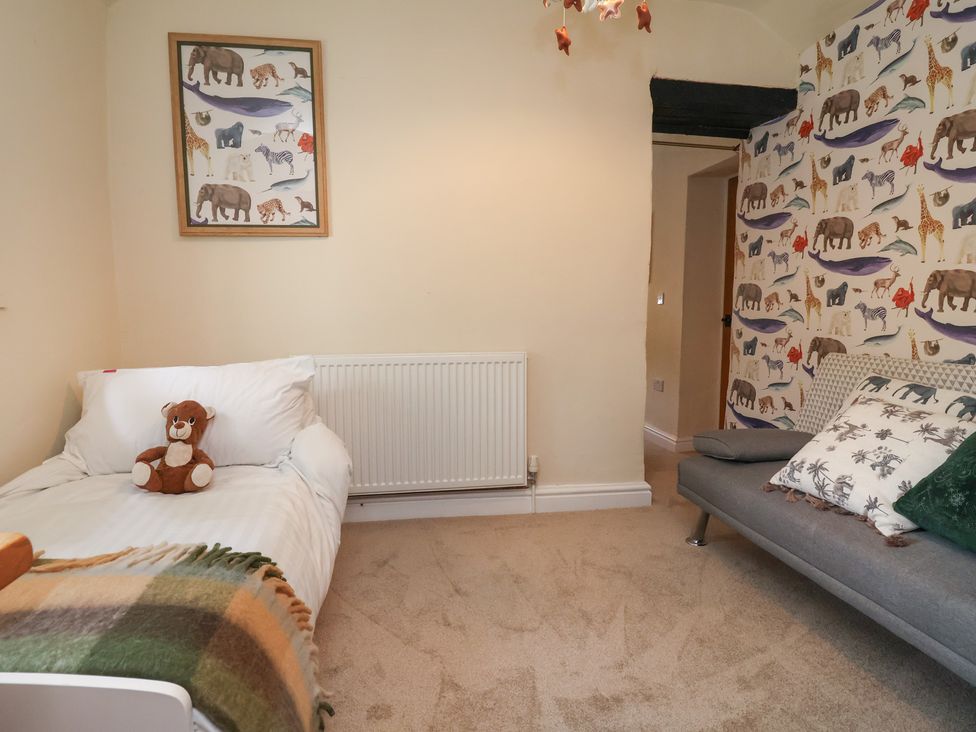 A bedroom with a bed and a teddy bear at Upstairs at the White Lion