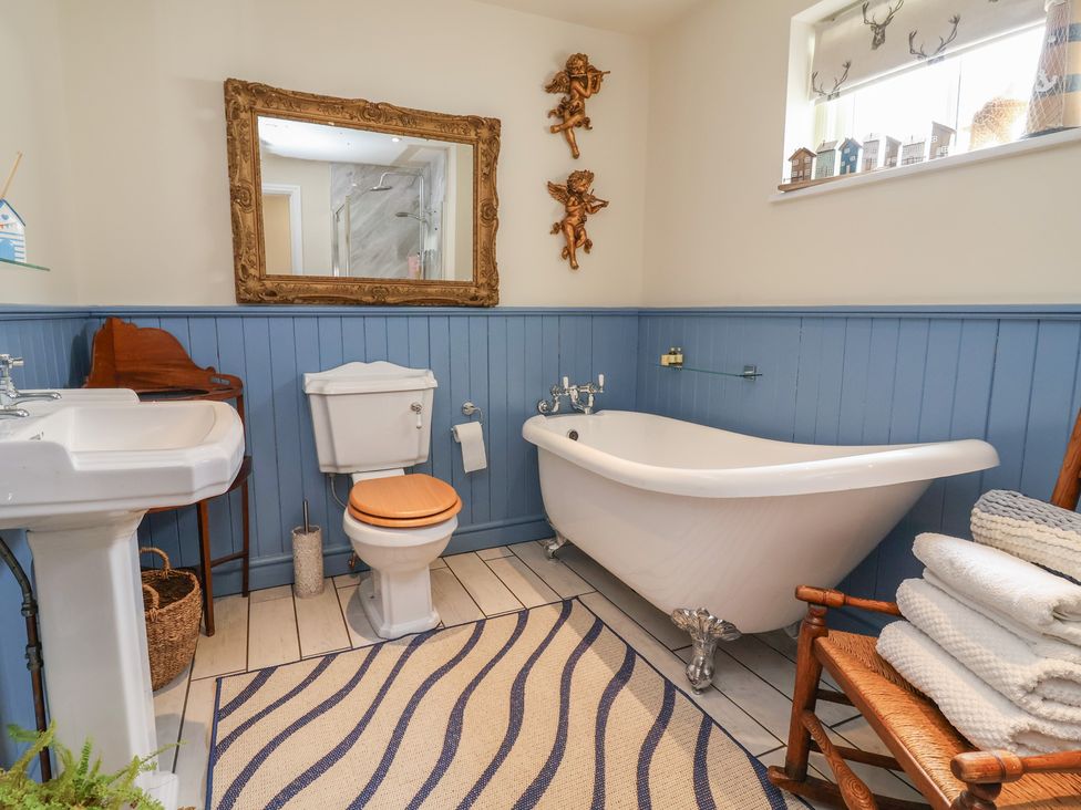 A bathroom with a bath tub and sink at Upstairs at the White Lion