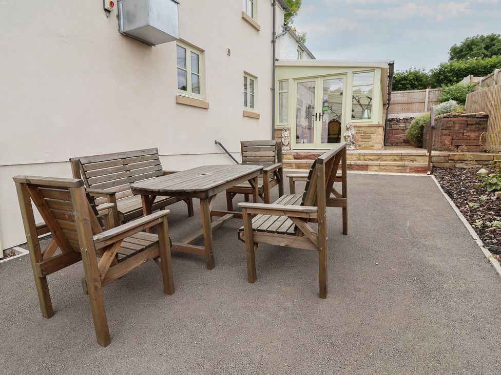 A patio area with a table and chairs at Upstairs at the White Lion