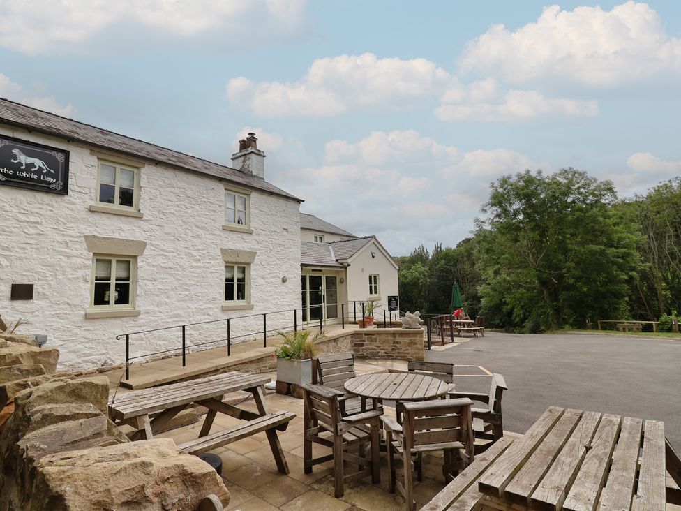 An outdoor seating area with tables and chairs at The White Lion