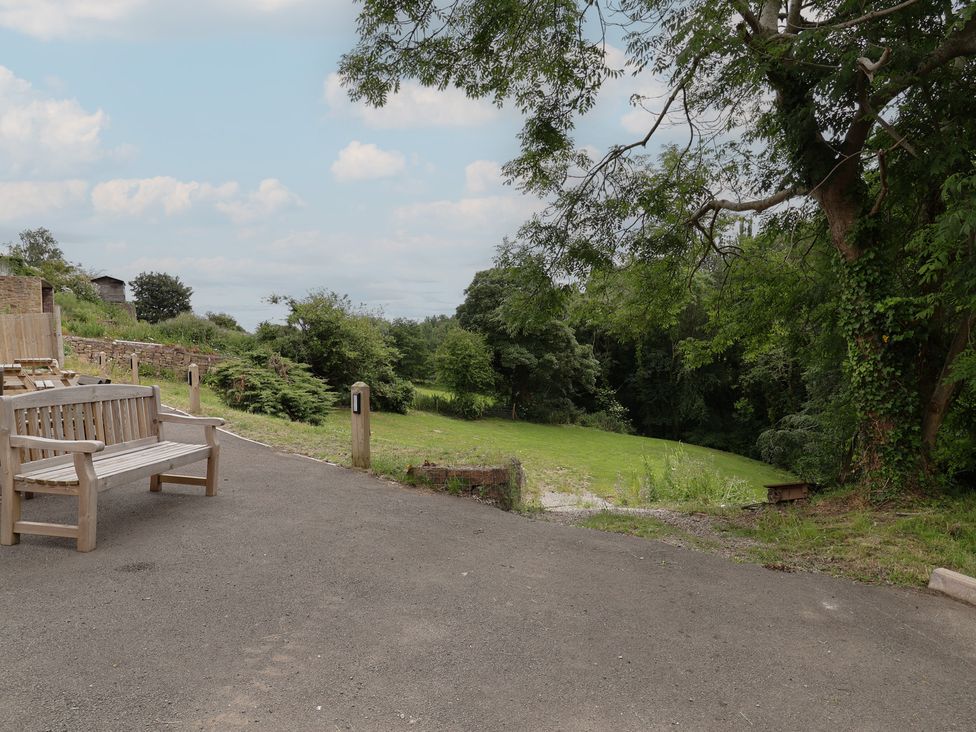 An outdoor area with a bench and grass at Upstairs at the White Lion in 