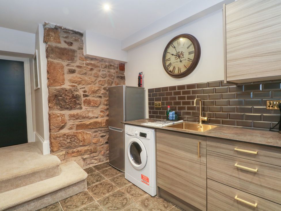 A kitchen with a washing machine and refrigerator at Lord William Cabus near Garstang