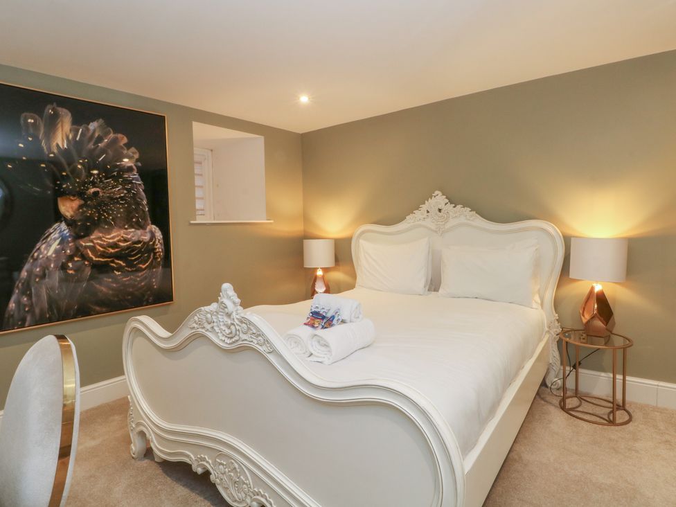 A bedroom with a bed and wall art at Lord William in Cabus near Garstang