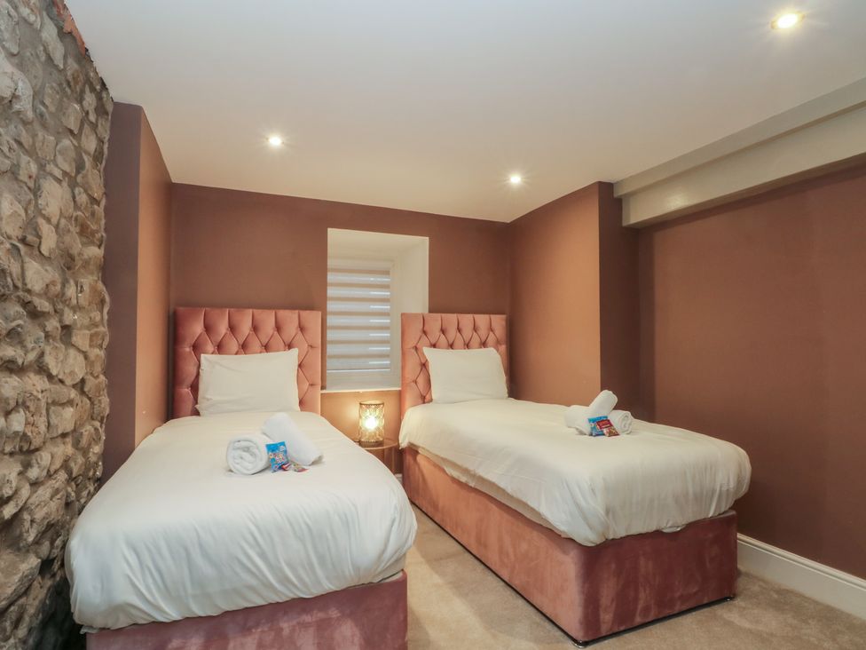 A bedroom with two beds and a window at Lord William Cabus near Garstang