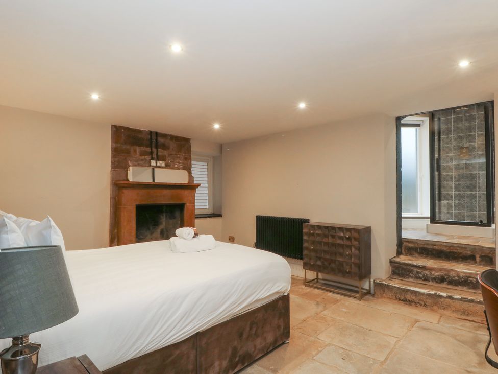 A bedroom with a bed and fireplace at Lord William in Cabus near Garstang