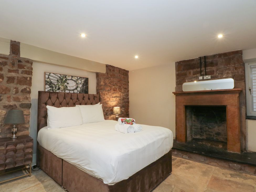 A bedroom with a bed and fireplace at Lord William in Cabus near Garstang