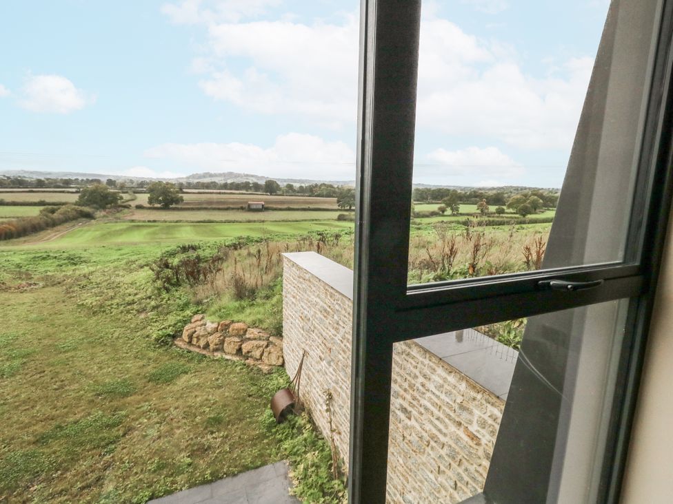 A view from a window showing a grassy landscape at Frogwell in Yetminster