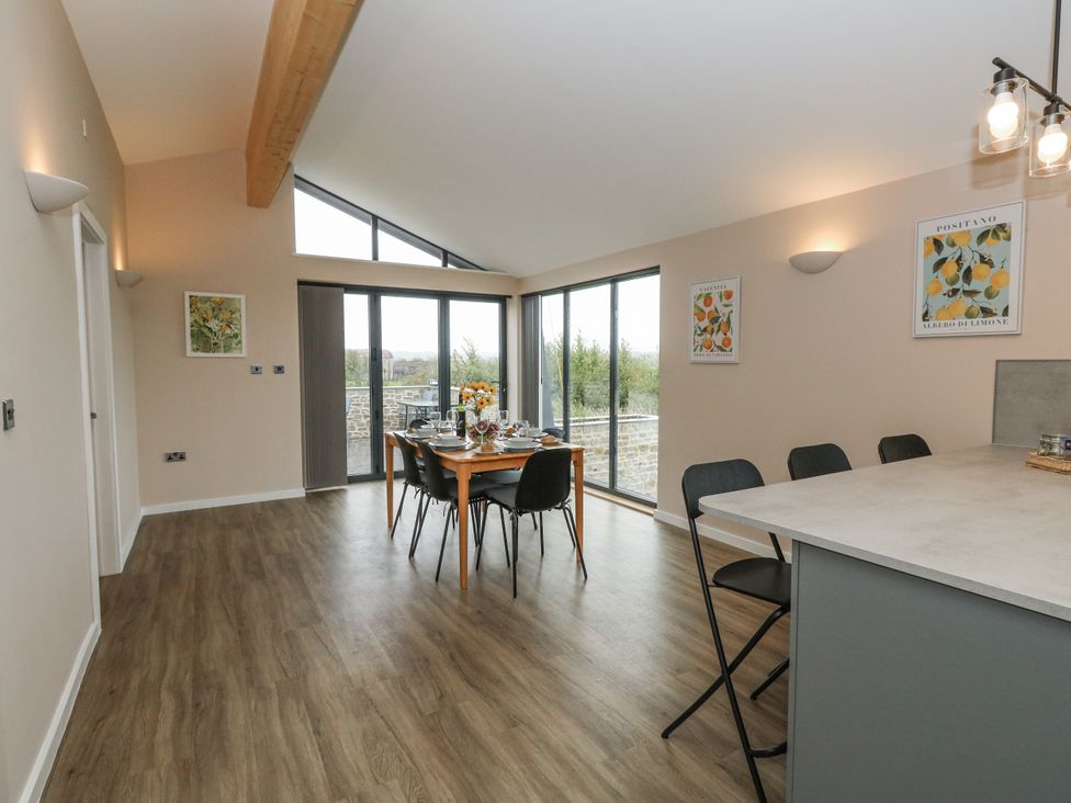 A dining room with a table set for meals at Frogwell in Yetminster