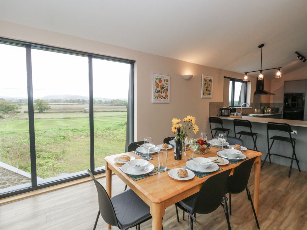 A dining room with a table set for a meal at Frogwell in Yetminster