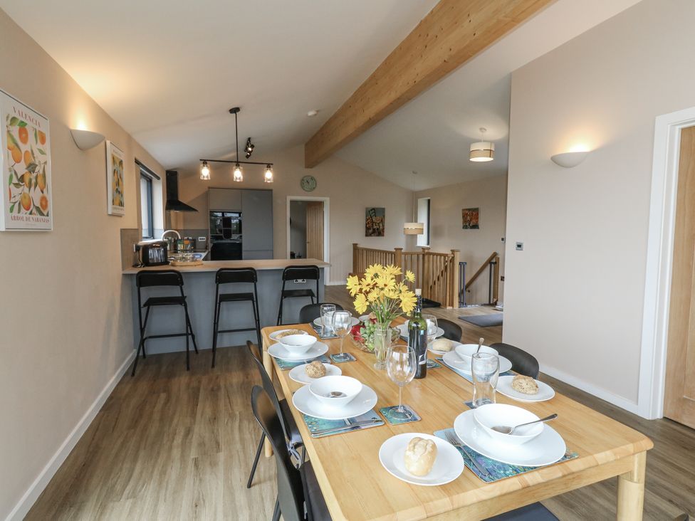 A dining room with a table set for a meal at Frogwell in Yetminster