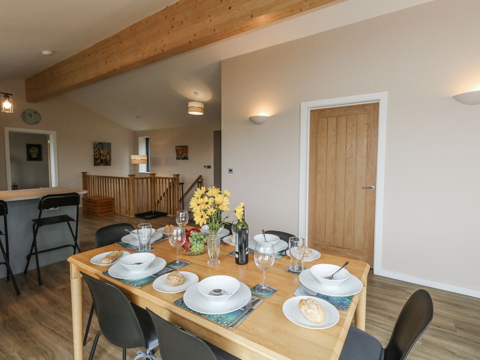 A dining room with a table set for a meal at Frogwell in Yetminster