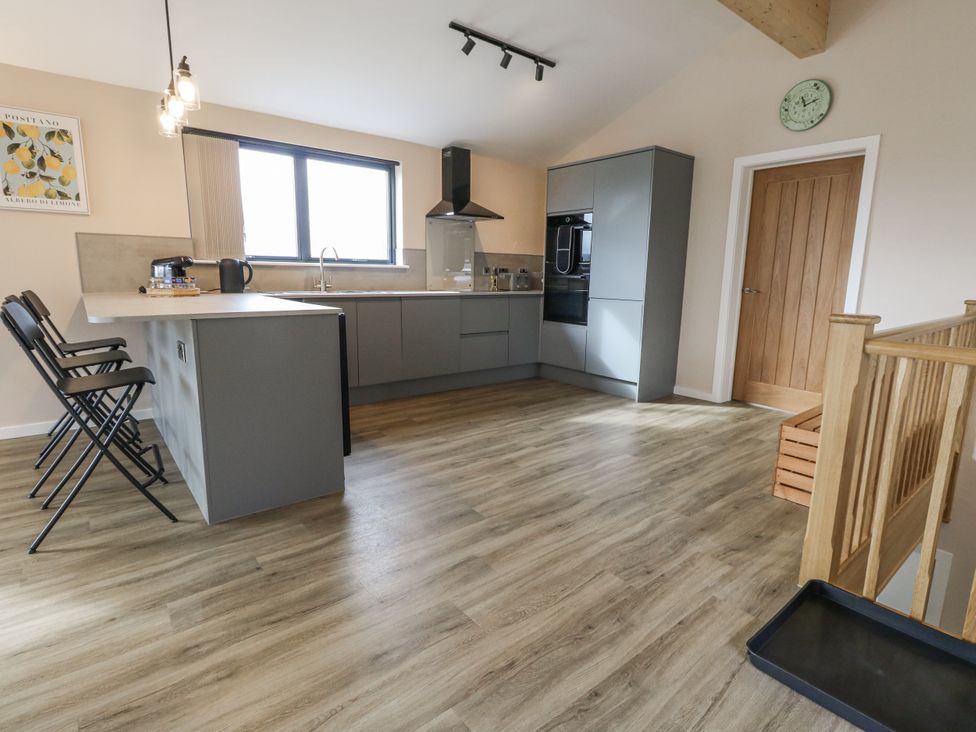 A kitchen with modern appliances and seating at Frogwell, Yetminster