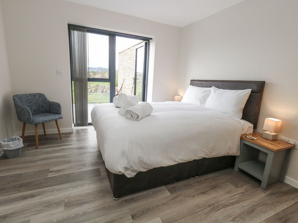 A bedroom with a bed and a chair at Frogwell in Yetminster