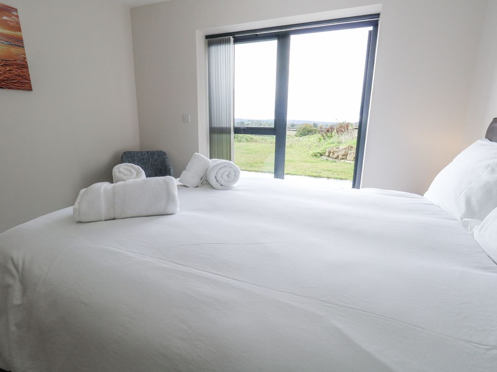 A bedroom with a bed and towels on top at Frogwell in Yetminster