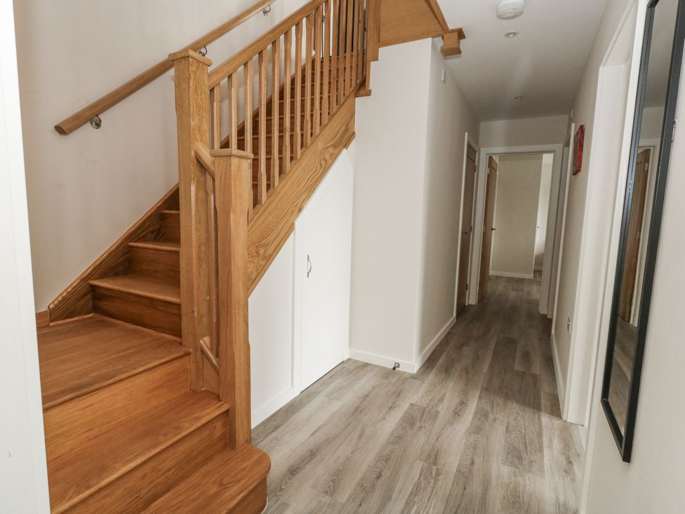A hallway with a staircase and doors at Frogwell in Yetminster