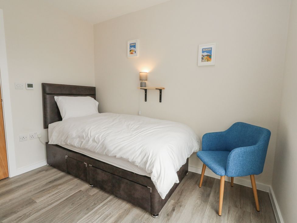 A bedroom with a bed and chair at Frogwell in Yetminster
