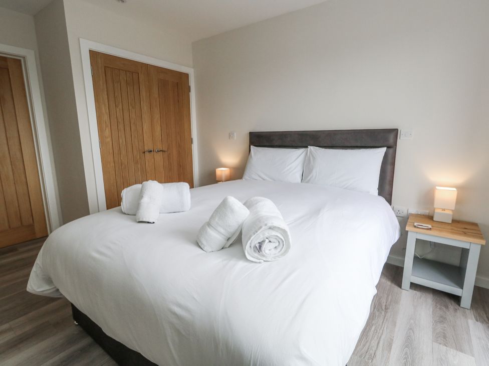 A bedroom with a bed and towels at Frogwell in Yetminster