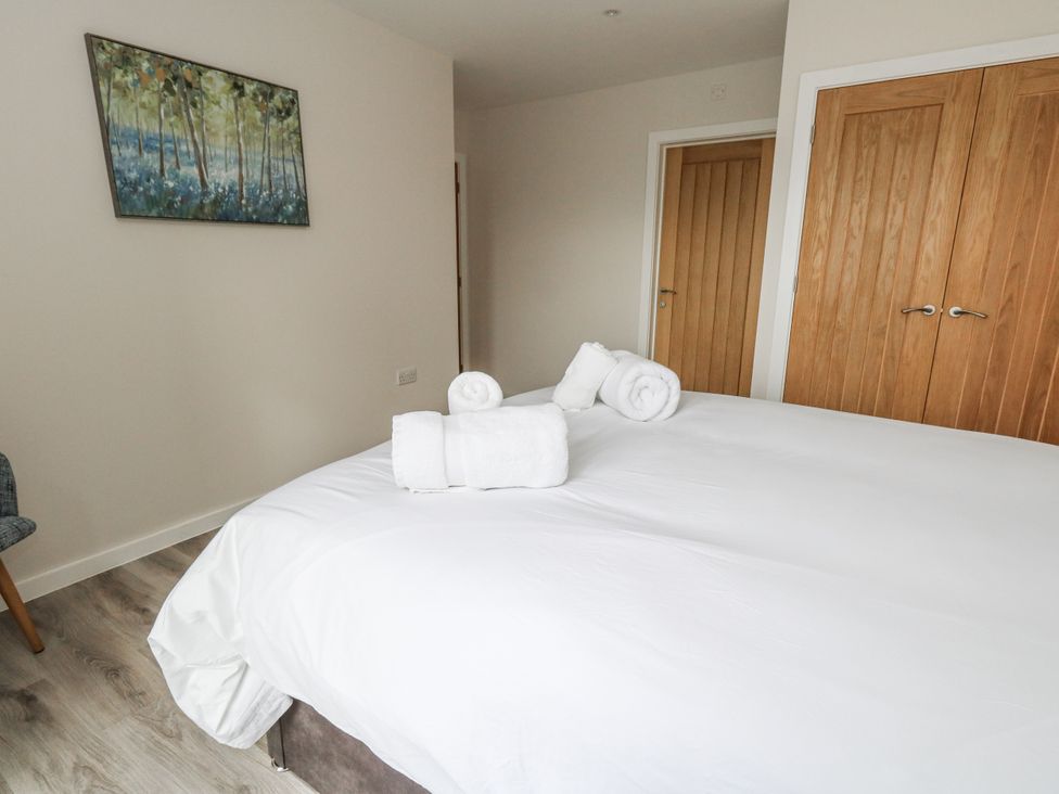 A bedroom with a bed and towels at Frogwell in Yetminster