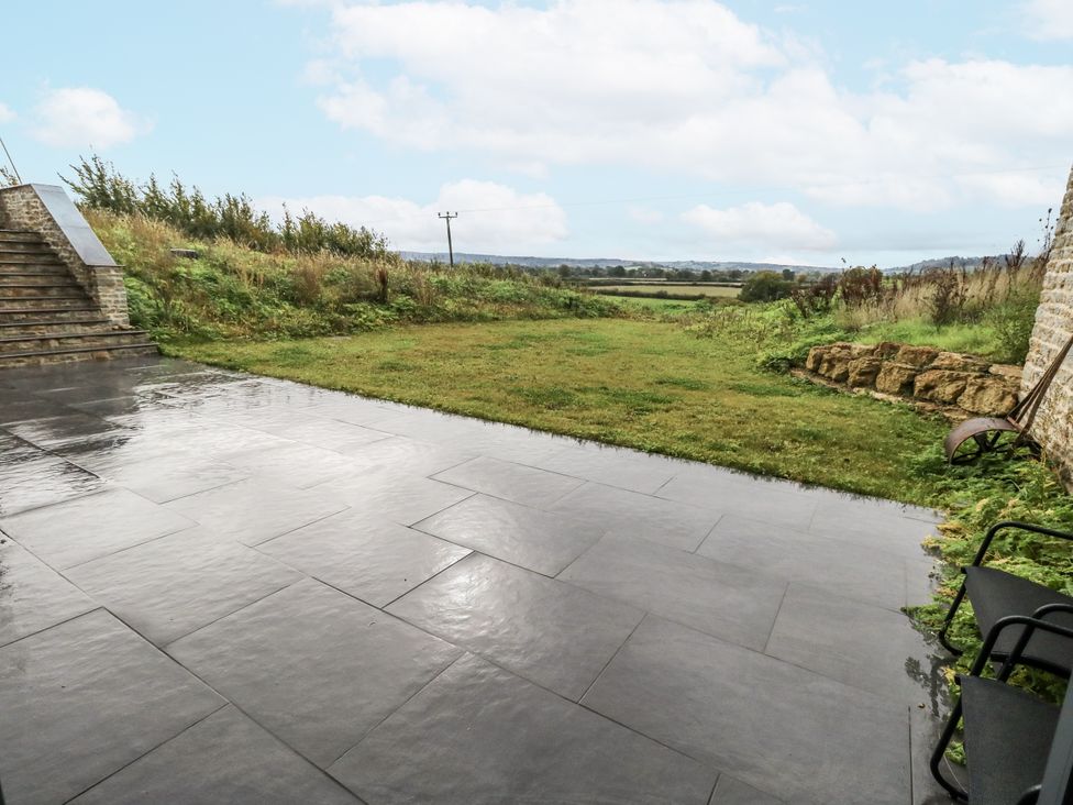 A garden with a patio and steps at Frogwell in Yetminster