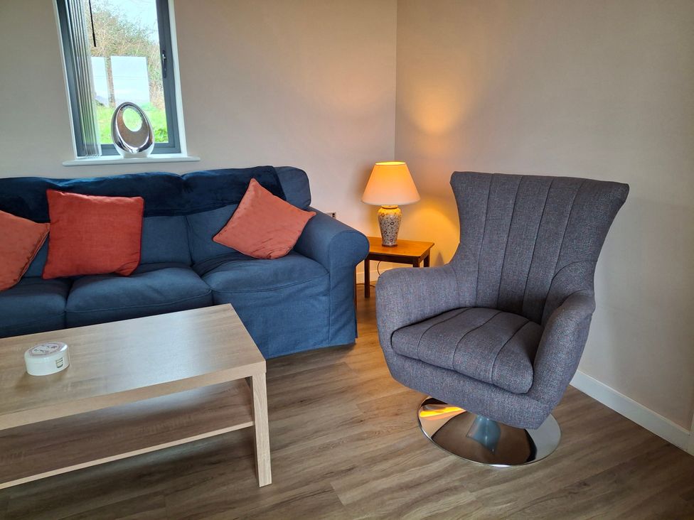 A living room with a sofa and a chair at Frogwell in Yetminster
