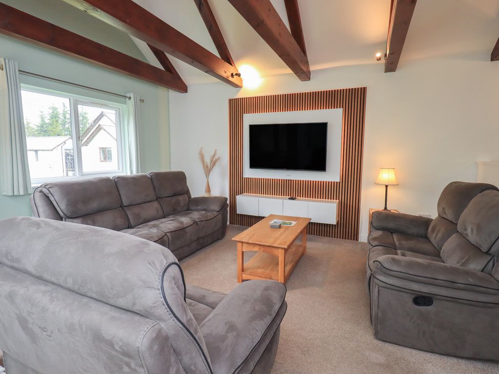 A living room with a sofa and a television at Whitbarrow 24 in Penruddock