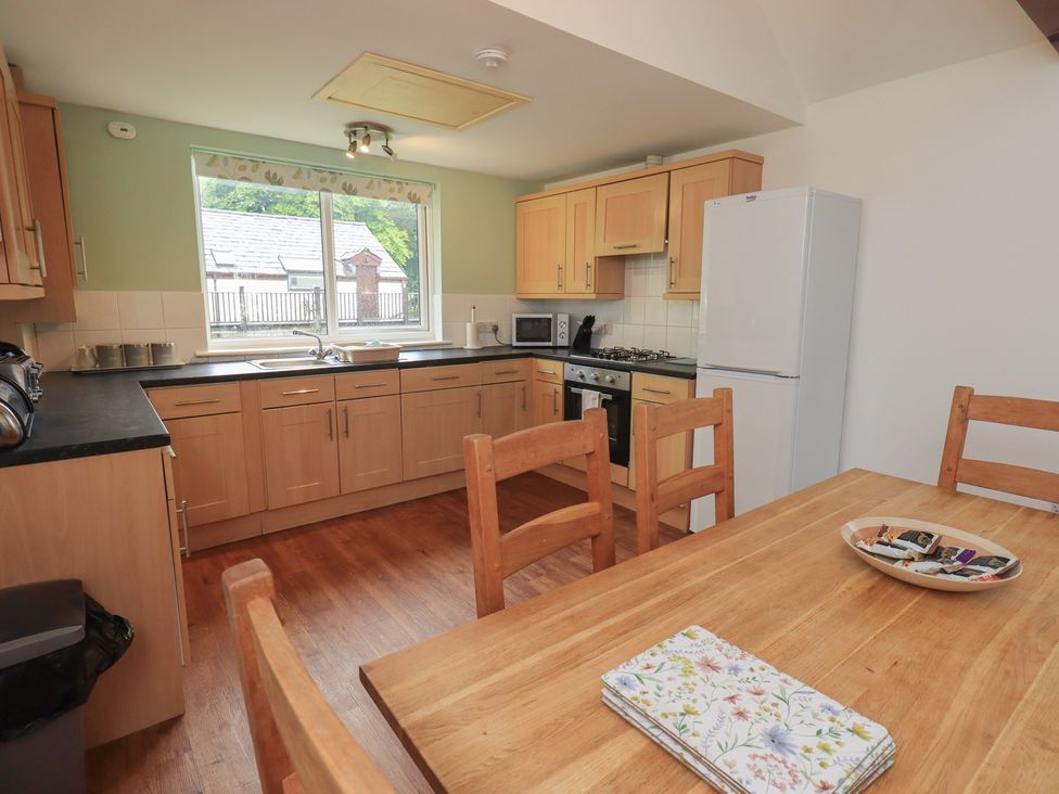 A kitchen with a table and chairs at Whitbarrow 24 in Penruddock