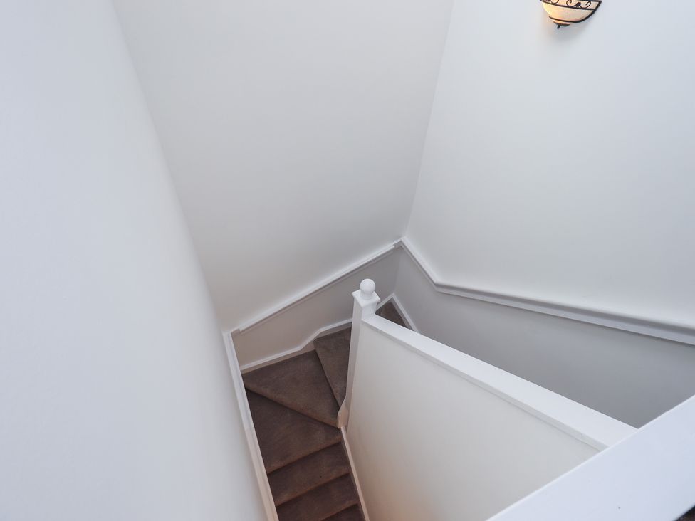 A staircase with a light fixture at Whitbarrow 24 in Penruddock