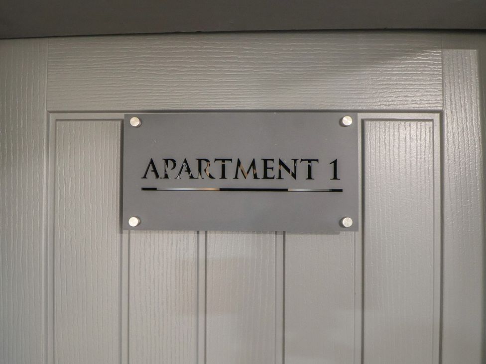 A door with a nameplate indicating Apartment 1 at The Cloud Apartment 1 Chester